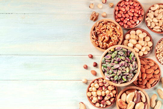 Nut variety, overhead flat lay shot on a teal rustic wooden background