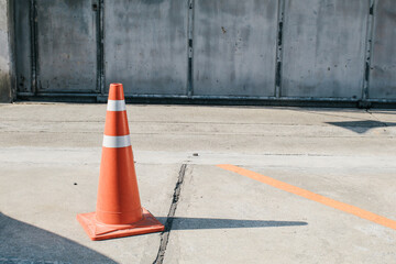 Traffic cone to mark road works or temporary obstruction. Orange traffic cone are placed to protect the dangers of driving or land traffic to ensure safety.