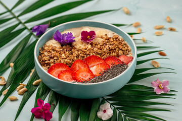 Bowl of granola yogurt with chia seeds and strawberries