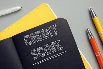 Business concept about CREDIT SCORE with phrase on the page. A credit score is a numerical...