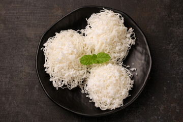 Noolappam/Idiyappam/rice noodles, a popular traditional steam cooked Kerala breakfast dish with hot and spicy egg roast curry on a houseboat, Alleppey, India. South Indian food. noolputtu Sri lankan
