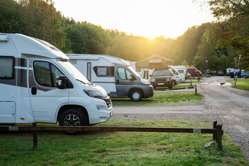 Camper vans in a camping park - obrazy, fototapety, plakaty