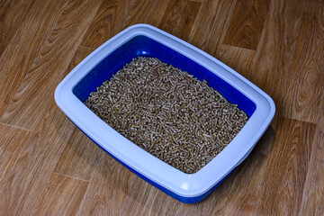 Pet litter box with filler on a floor