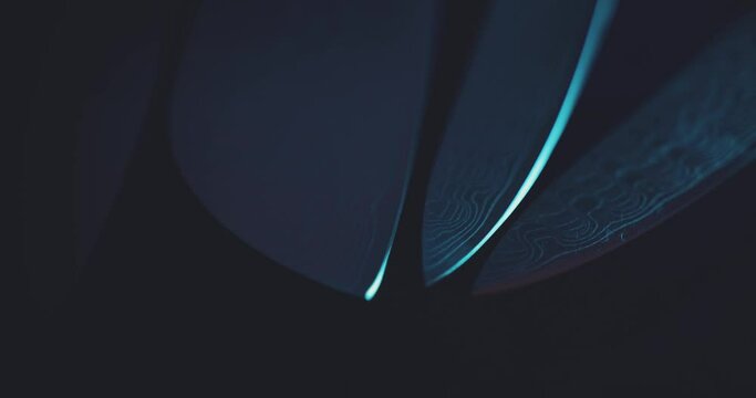 Lighting tip of sharp chef knives with roving light - macro close up of steel blades