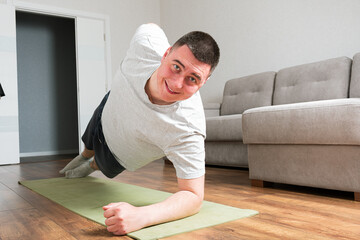 Sporty young man do exercises at home