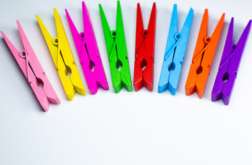 Colorful wooden clothespins on white background. Close up, copy space.
