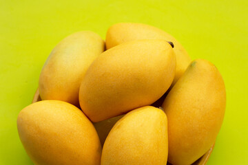 Tropical fruit, Mango on green background.