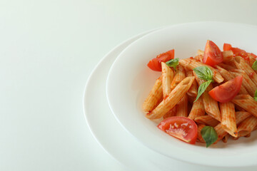 Plate with pasta with tomato sauce on white background