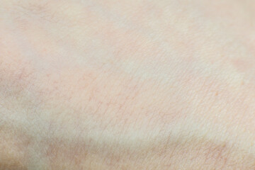 Soft focused Human skin with hairs texture background. Macro photo, close up.