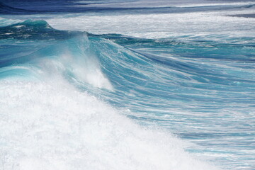 Naklejka na ściany i meble turquoise big wave of the sea rolling with white foam on the tropical island of La Réunion, France