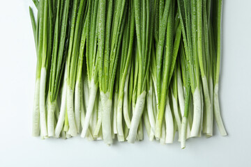 Fresh green onion with water drops on white background