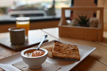 Toasted bread with tomato. Toast with crushed tomato. Delicious continental breakfast. Breakfast of toast with tomato, coffee and orange juice.