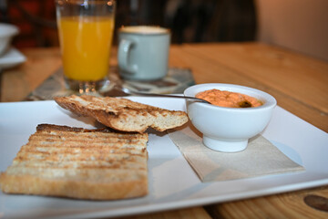 Toasted bread with tomato. Toast with crushed tomato. Delicious continental breakfast. Breakfast of toast with tomato, coffee and orange juice.