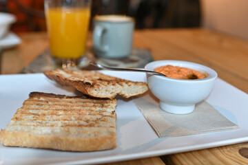 Toasted bread with tomato. Toast with crushed tomato. Delicious continental breakfast. Breakfast of toast with tomato, coffee and orange juice.