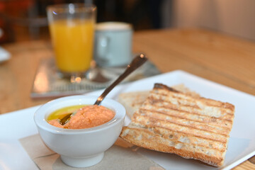 Toasted bread with tomato. Toast with crushed tomato. Delicious continental breakfast. Breakfast of toast with tomato, coffee and orange juice.