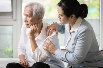 Sad elderly with depression,asian female caregiver or daughter comforting,care,encourage her old mother,tired senior woman feeling stressed and hopeless,worried about senile disease,health problems