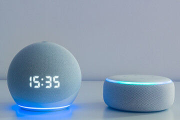 Voice controlled speaker with activated voice recognition, on light background.