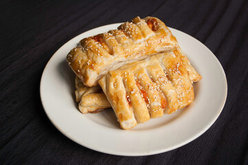cooking baking confectionery oven puffs dough sausage in dough black background