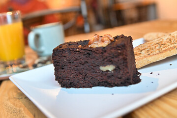 Chocolate brownie. breakfast with brownie, toast, coffee and orange juice.