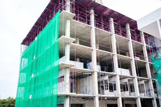 New building under construction site with green slan and scaffolding