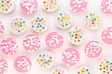 Colorful cupcakes on a white background.