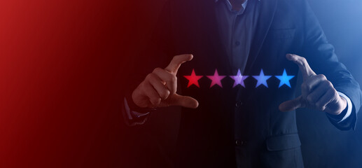 Man hand showing on five star excellent rating.pointing five star symbol to increase rating of company.Review, increase rating or ranking, evaluation and classification concept