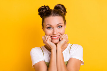 Photo of adorable charming lady hands cheekbones toothy smile wear green overall isolated yellow background