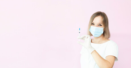 Smiling nurse in medical mask and gloves holding syringe for vaccine injection.