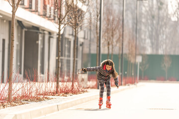 Cute little girl rollerblading. sports and entertainment.