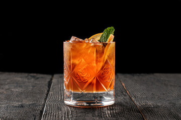 Side view on fresh alcoholic cocktail garnished with orange
