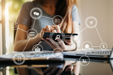  Woman using smart phone for mobile payments online shopping,omni channel,sitting on table,virtual...