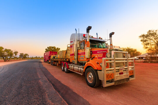 Ghan, Northern Territory, Australia - August 2019: Western Star road-train truck of Western Star road-train truck of Neil Mansell transport service. Crossing A87 Stuart highway of Australian Outback.