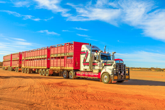 Marla, South Australia, Australia - August 29, 2019: Kenworth road-train truck of Hayson Haulage of Alice Springs. Crossing Marla town on A87 Stuart highway of Australian Outback.