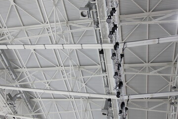 Metal roof frame with lighting and ventilation systems of a modern sport arena building, texture for bachground