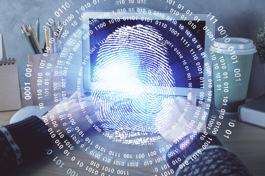 Double exposure of woman hands typing on computer and fingerprint drawing. Security concept.