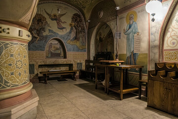 Kyiv, Ukraine - August 19, 2020: Icons with the faces of saints and ancient frescoes on the stone...