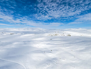 Stunning panoramic view over snow capped arctic mountains and wilderness terrain on a clear cold winters day.