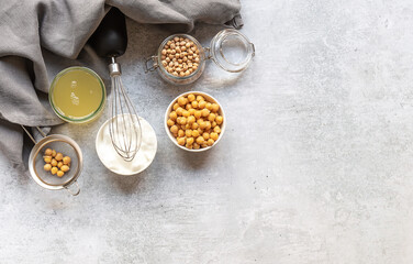 Whipped foam in a bowl from canned chickpea aquafaba. Egg replacement and substitutes for vegan cooking. Top view, copy space. 