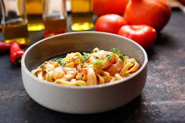 Tagliatelle with prawns in tomato and cream sauce.
Culinary photography. Suggestion to serve the dish.
