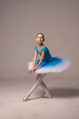 young ballet dancer posing.  Ballerina in a ballet tutu and pointe shoes. The child ballerina is dancing. Girl on isolate
