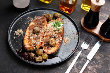 Baked eggplant steak with Brussels sprouts.
Culinary photography. Suggestion to serve the dish.