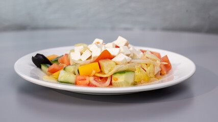 Healthy eating Greek salad on a gray background
