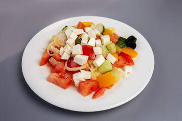 Greek salad on a gray background. Healthy eating