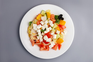 Healthy eating Greek salad on a gray background top view