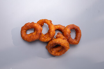 onion rings to beer on a gray background top view