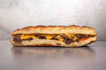Fast food. bun with cheese and meat on a gray background