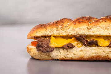 sandwich with cheese in a fresh loaf on a gray background