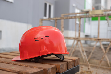 protective helmet and notebook on the background of the construction site