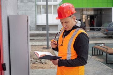  specialist electrical substation engineer inspect modern high-voltage equipment. Energy. Industry
