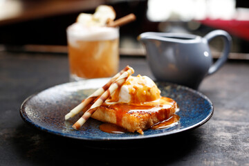 Apple pie with vanilla ice cream and caramel sauce.
Appetizing sweet dessert. Culinary photography.